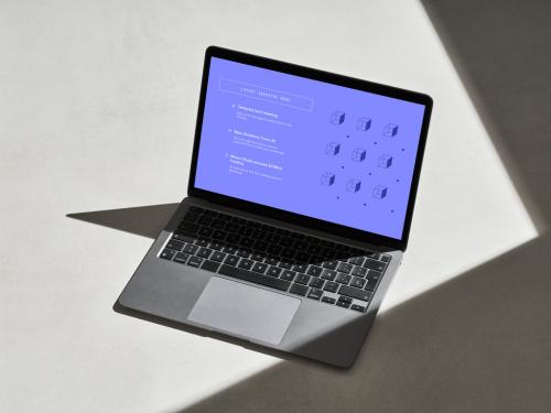 Silver Laptop on a Concrete Surface with Shadows - 478873567