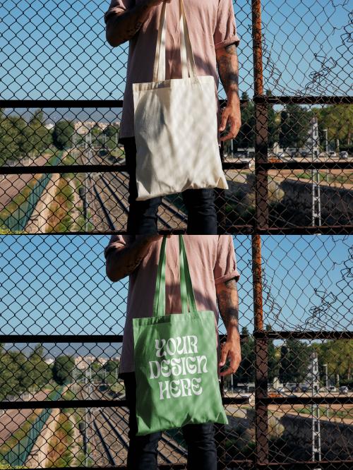 Man Holding a Tote Bag Mockup With Custom Colors and Design