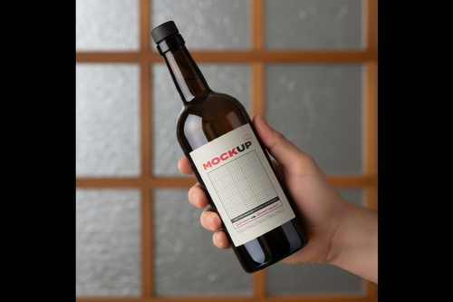 Hand Holding Bottle Collection Label Mockups