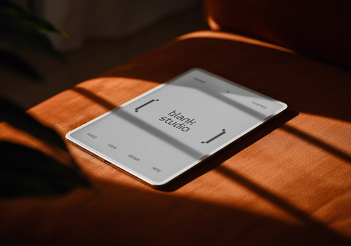 Ipad Mockup on top of Orange Sofa