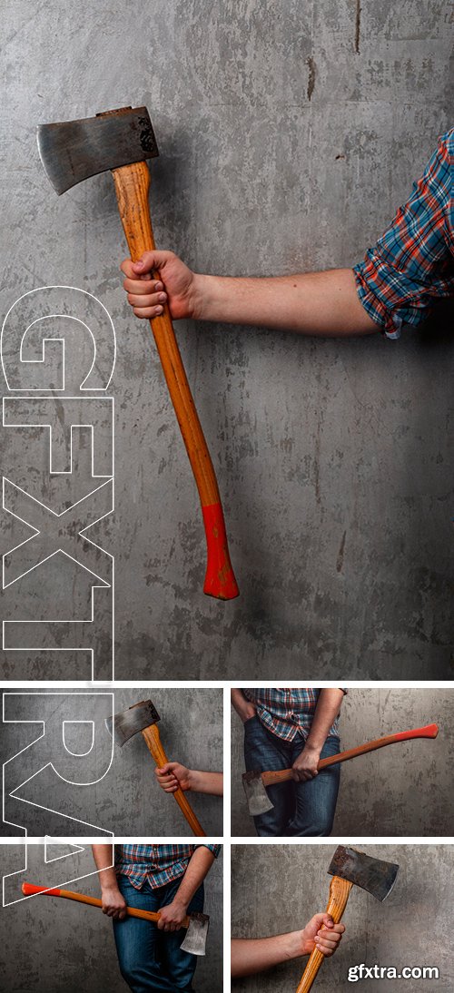 Stock Photos - Axe in male hand over old dirty wall