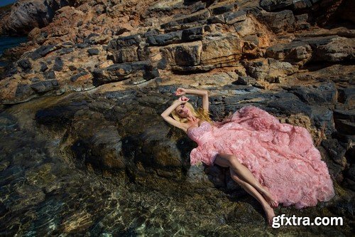 The blonde in a pink dress on the island