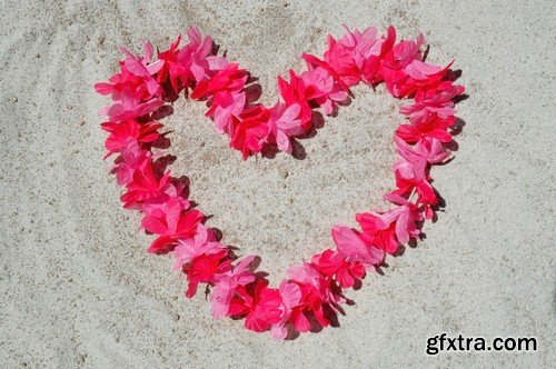 Heart of flowers on the sand