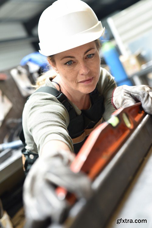 Female metalworker working on machine 8X JPEG
