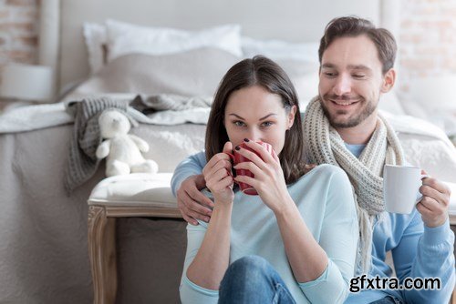 Happy young couple in a cozy bedroom - 20xUHQ JPEG Photo Stock