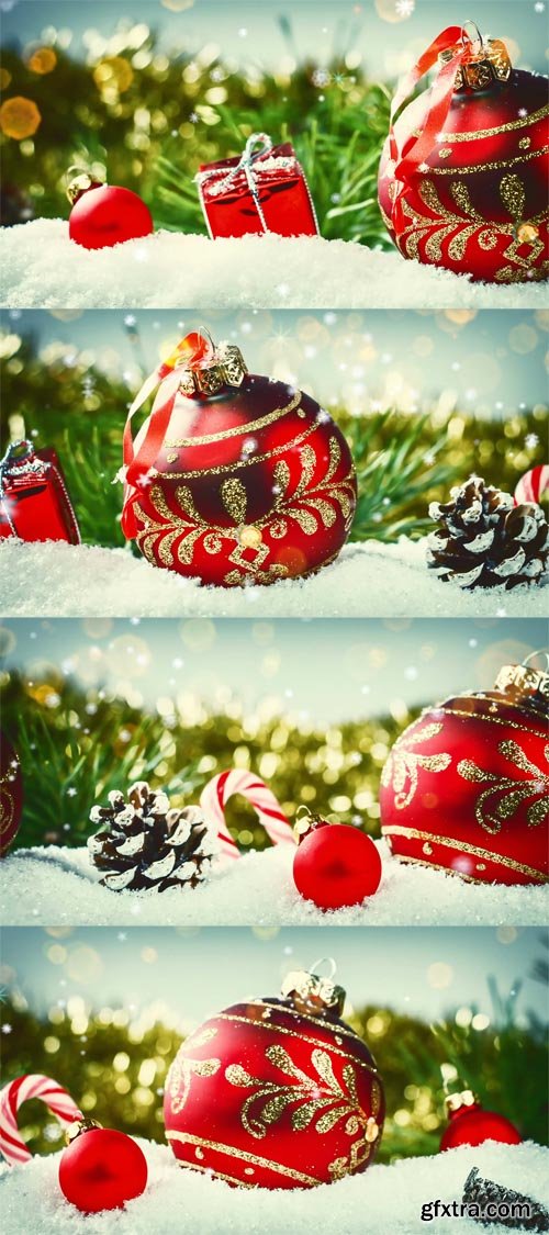 Christmas holiday setting with red baubles and presents laying in snow Christmas holiday setting with red baubles and presents laying in snow