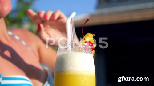 Pond5 - Woman Drinking Tropical Cocktail At Beach Resort