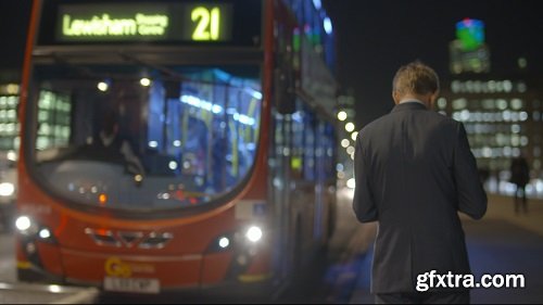 Red London Bus Passing Man on London Bridge