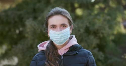 Videohive - Attractive Girl Takes on Medical Mask During Coronavirus COVID-19 Epidemic