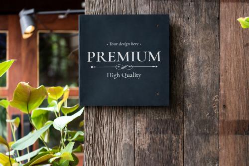 Black signage mockup on a wooden wall - 844036