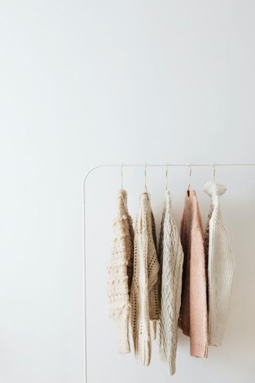 Casual knitted sweaters hanging on a rack - 2255404