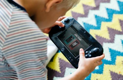 Young boy playing a portable video game - 538990