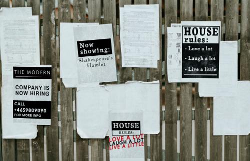 Sheets of paper ads on a wooden fence - 539183