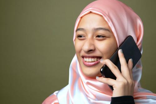 Portrait of a Muslim woman using a mobile phone - 2223219