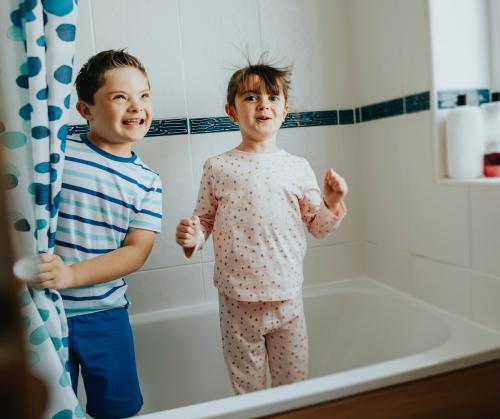 Sister and brother playing peekaboo in the bathroom - 2024883