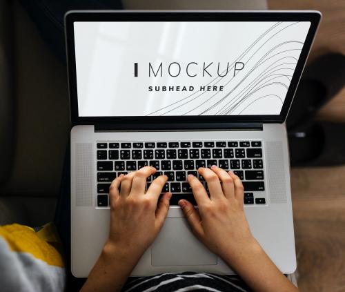 Woman using a laptop with a screen mockup - 502993