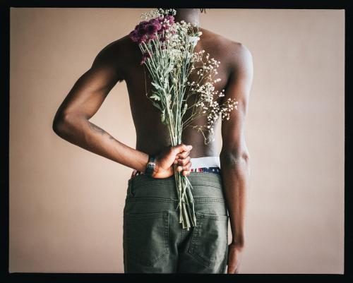 Black male model with flowers in a studio photoshoot - 2268709