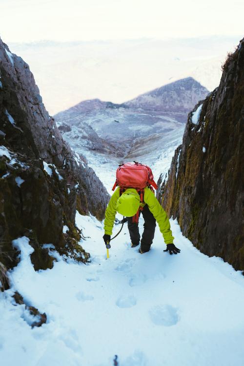 Mountaineer climbing a snow mountain - 2097699