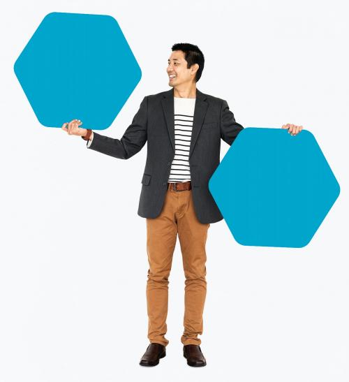 Cheerful man showing blue hexagon shaped boards - 490956