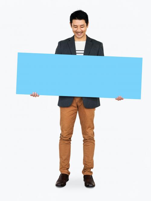 Cheerful man showing a blank blue banner - 491074