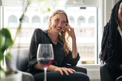 Woman having a glass of red wine with friends - 1220777
