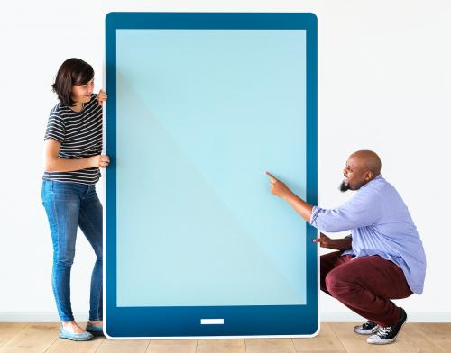 Diverse couple holding a tablet with graphics - 405238