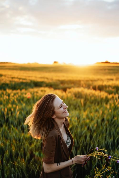 Cheerful woman in a field - 1207943