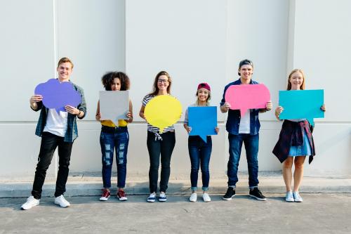 Young adult friends holding up copyspace placard thought bubbles - 383961