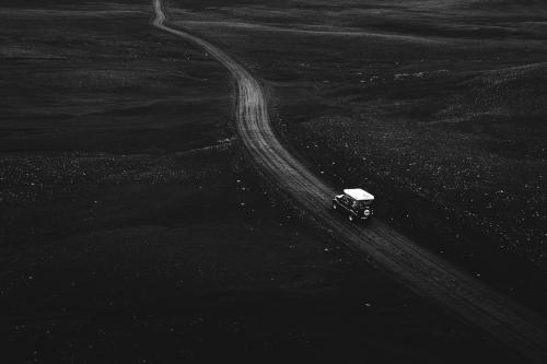 Drone view of a Suzuki Jimny driving on a dirt road - 1206097