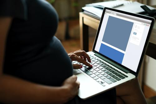 Pregnant woman is using computer laptop - 259300