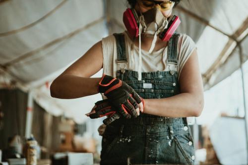 Female carpenter wearing personal protective equipment - 1199228