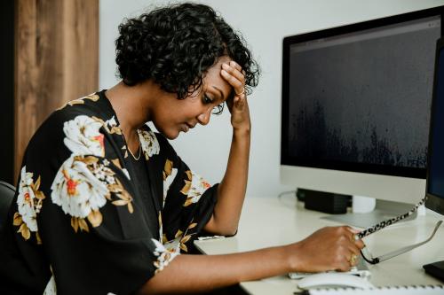 Stressed black businesswoman working in the office - 1204936
