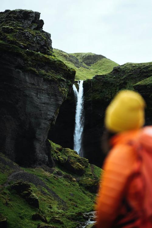 Female hiker with a view of Kvernufoss waterfall in South Iceland - 1206158