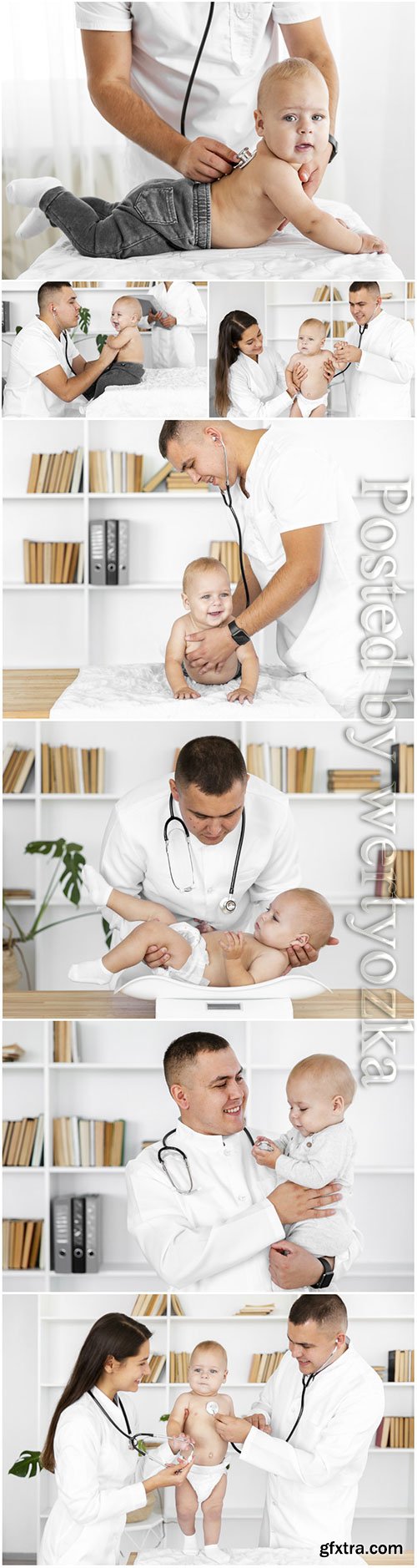 Doctor hands listening little baby stock photo Doctor hands listening little baby stock photo