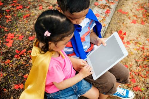 Superhero kids using an empty screen digital tablet - 5283