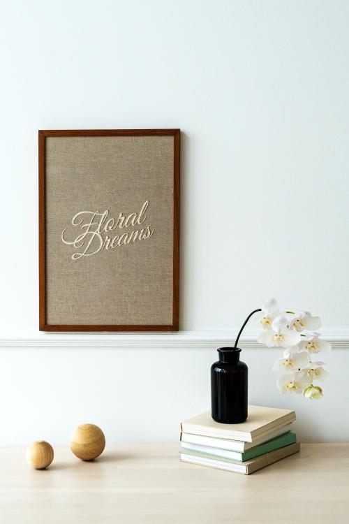 Wooden photo frame mockup hanging on a white wall - 1215271