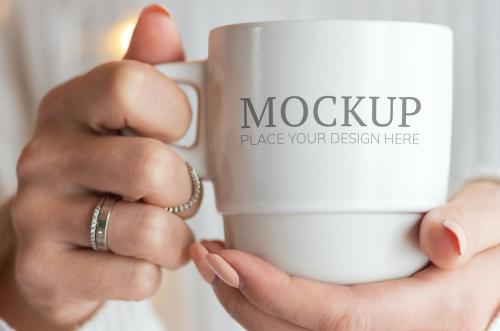 Woman in a white sweater with a white cup mockup - 1231718