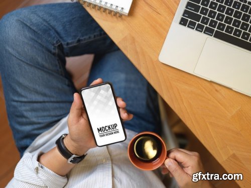 Hand holding smartphone mockup and christmas decorations