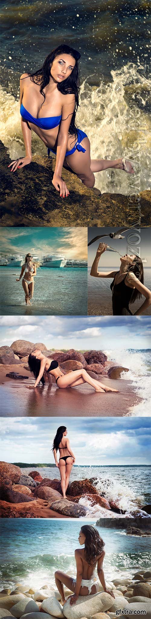 Girls on the seashore sitting on stones stock photo Girls on the seashore sitting on stones stock photo