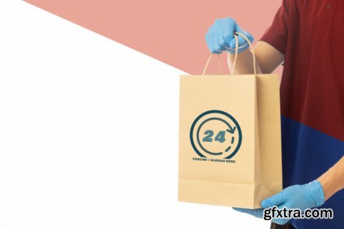 Closeup delivery man hand in medical gloves holding cardboard box mockup