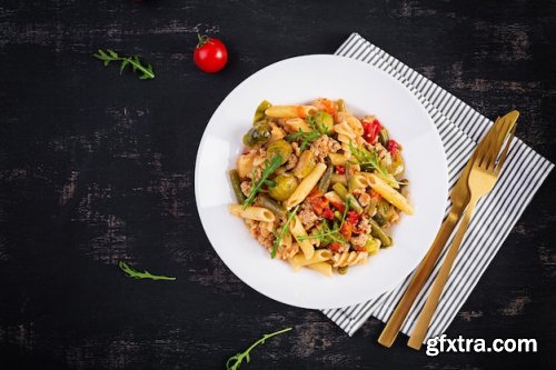 Italian pasta penne and fusilli with minced meat and vegetables