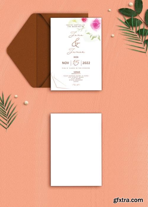 Wedding Invitation or stationery mockup with envelope, pearls, and green leaves on textured background. 545903873