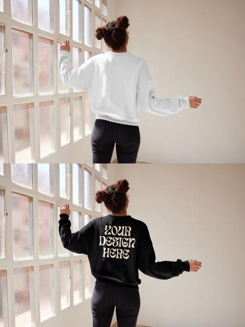 Mockup of woman wearing sweatshirt with customizable color by window view with arms out 640121133