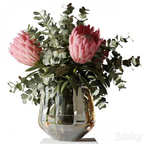 Bouquet with three white proteas and eucalyptus branches in a glass vase