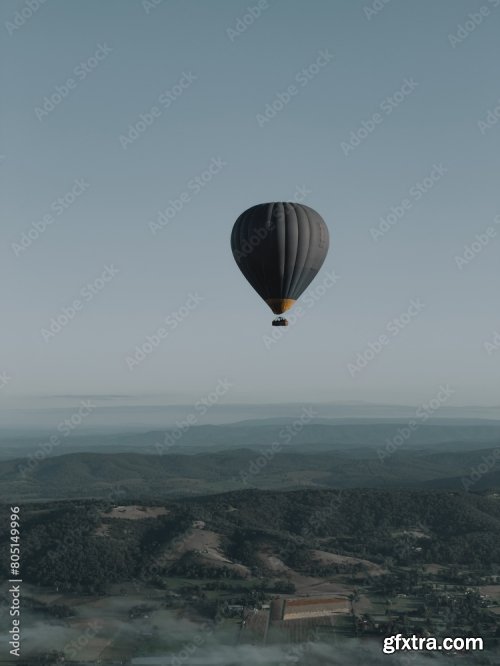 Hot-Air Balloon Flying Over The Hills And Mountains Above The Clouds 6xJPEG