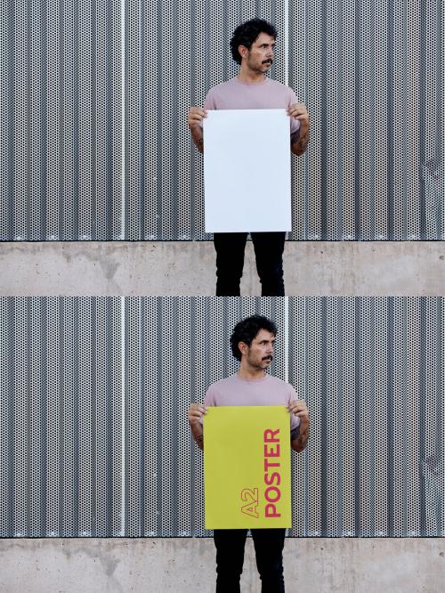 Man Holding A2 Poster Mockup in front a Metallic Wall
