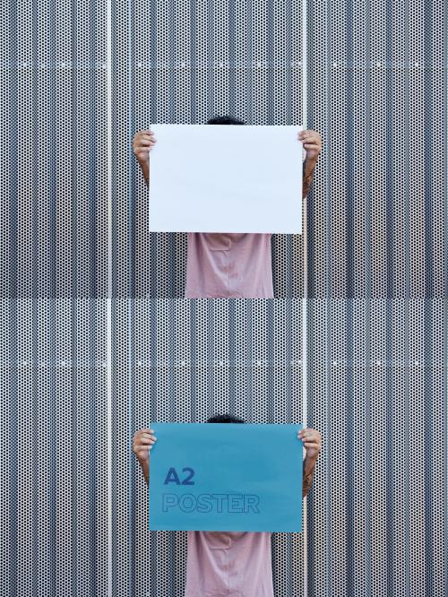 Anonymous Man Holding an Horizontal A2 Poster Mockup